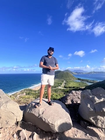 Paul Singh on a ridge overlooking the Caribbean and Atlantic in St. Kitts